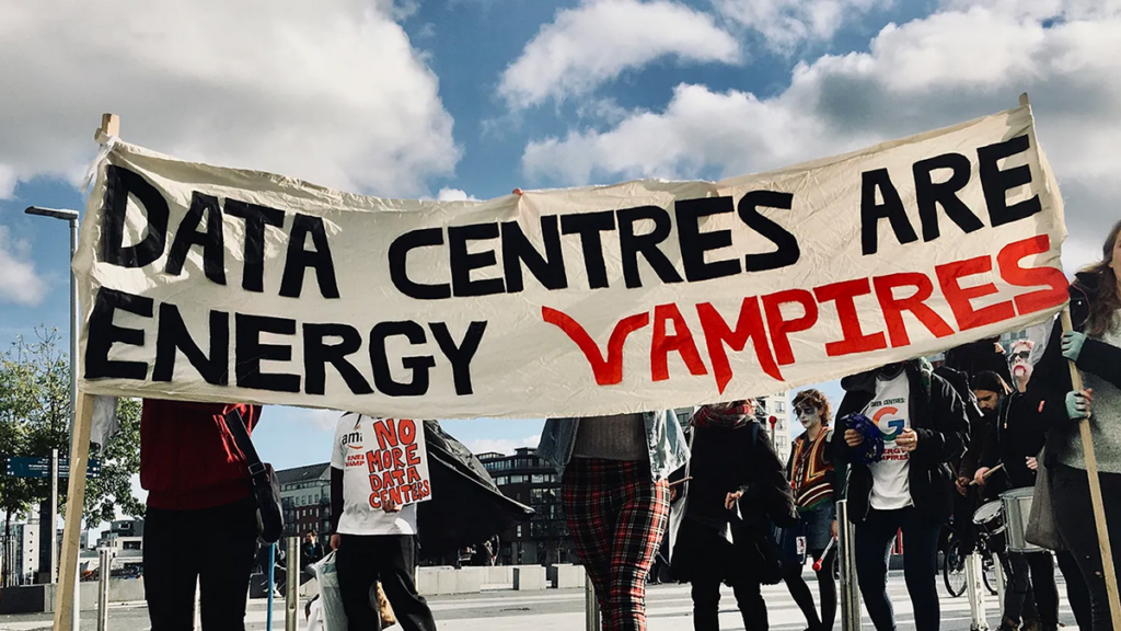 Protesters holding data centers energy vampires banner